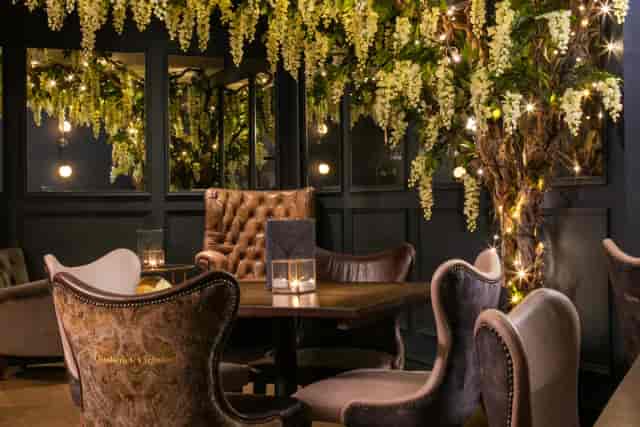 The Secret Room lounge with lush floral decor for VIP events and networking.