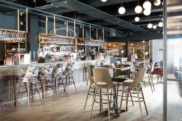 Chic lounge cocktail bar with ambient lighting for corporate networking and VIP reception events.