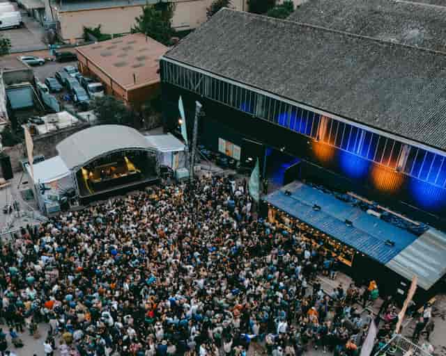 Industrial festival venue with stage and lighting for brand activations and corporate events.