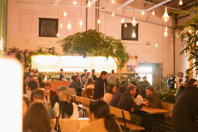 Wiper and True Taproom with high ceilings: versatile networking and conference reception venue.