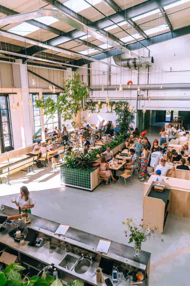Industrial event space with bench seating for corporate networking and social events.