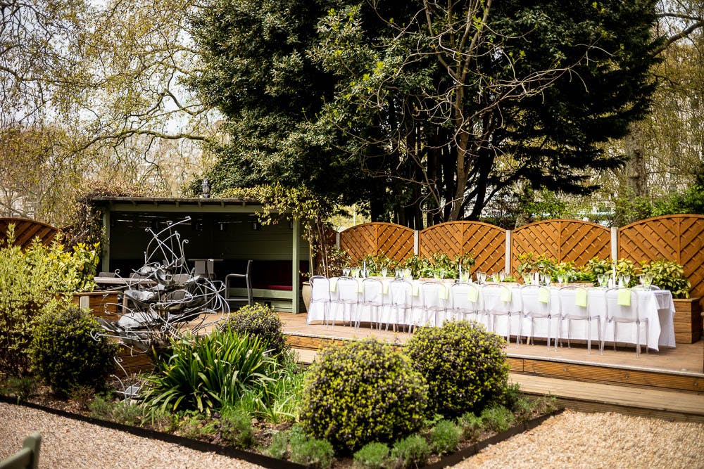 Elegant outdoor garden event space with floral centerpieces for gatherings and retreats.