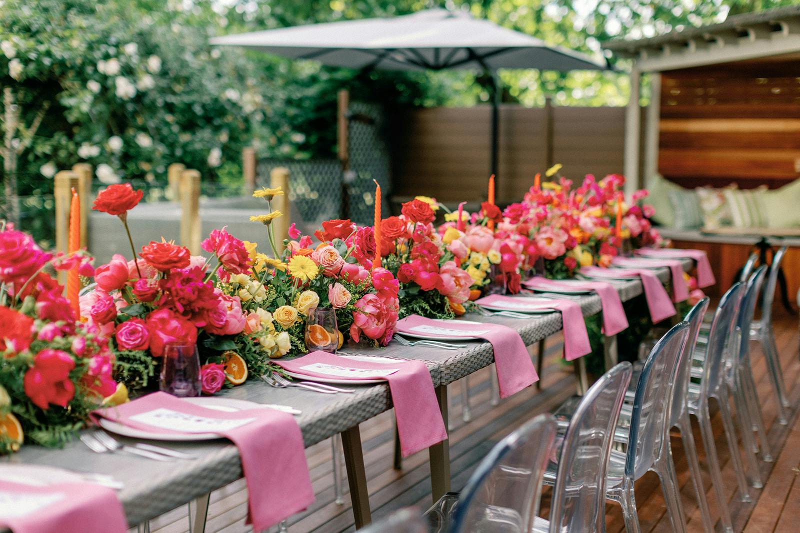 Elegant outdoor dining setup with floral centerpieces for upscale events.