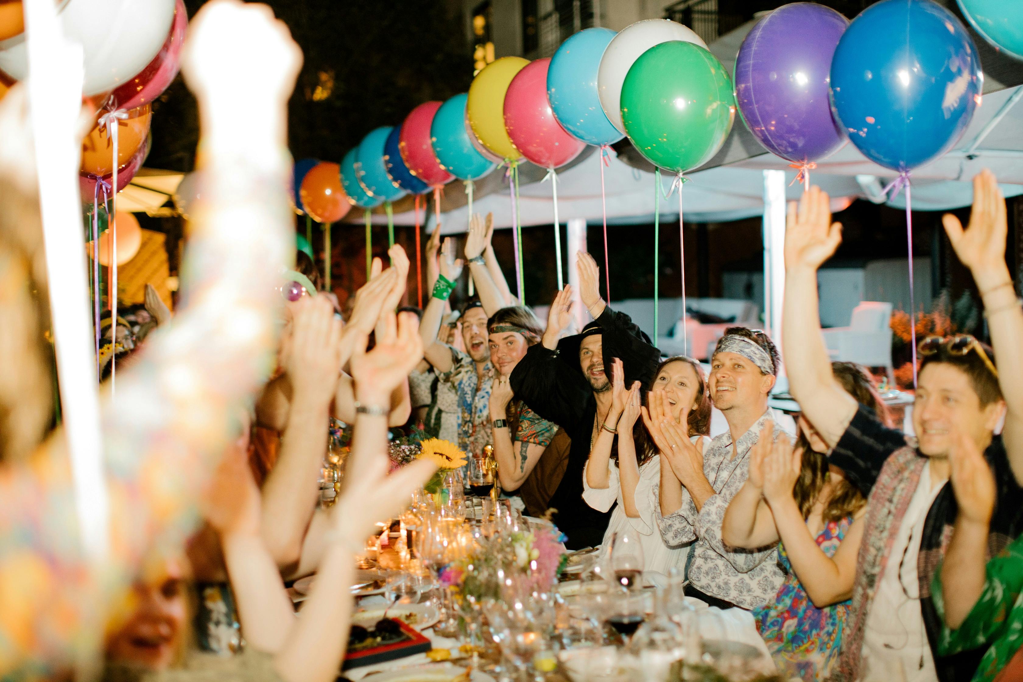Vibrant garden celebration with colorful balloons and joyful guests at Six Park Place.