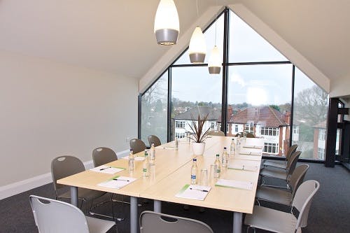 Modern Wilberforce Room with long table, ideal for corporate meetings and workshops.