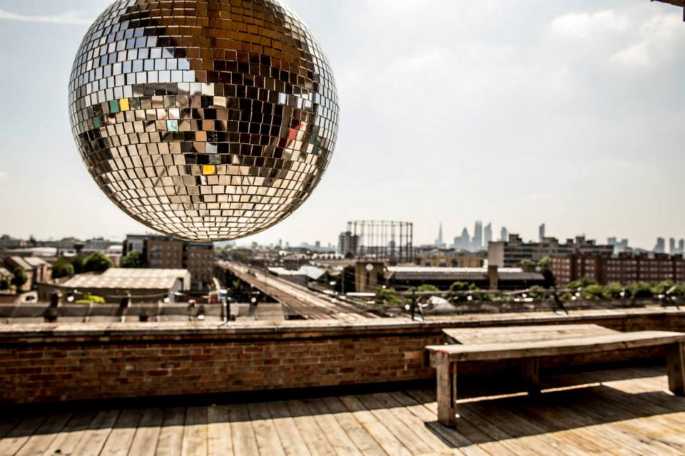 Rooftop bar with disco ball, ideal for corporate events and social celebrations. - Banner