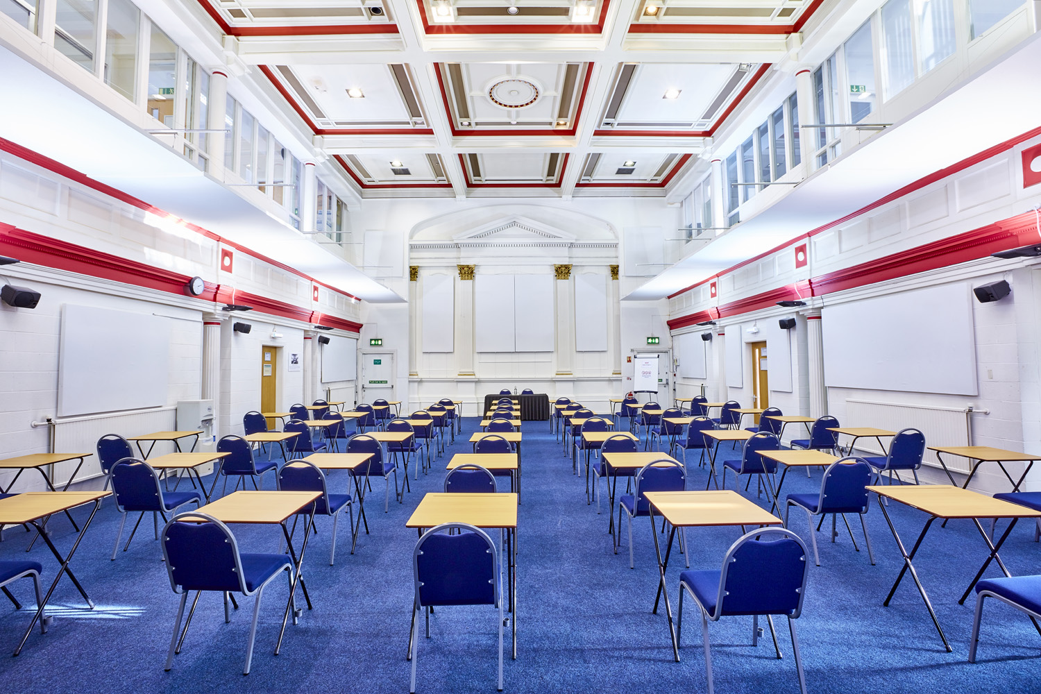 Spacious Main Hall in St Thomas Centre set for a seminar with tables and chairs. - Banner