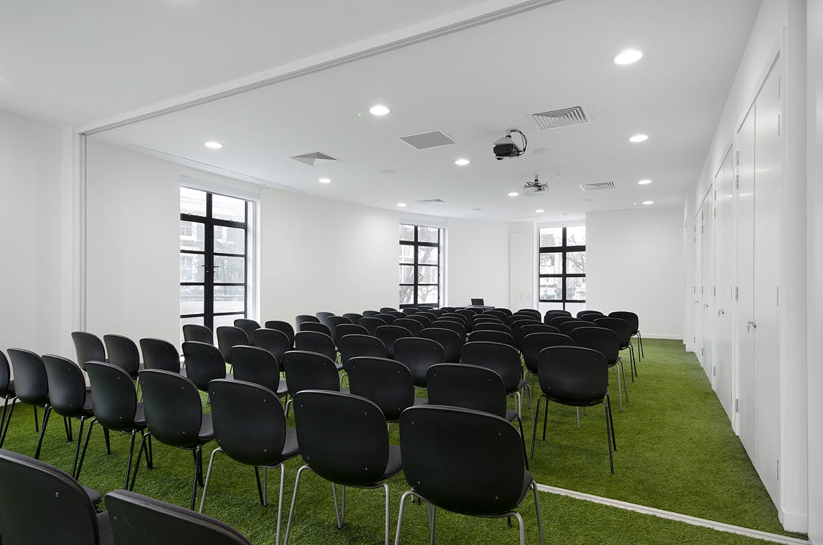 Conference Room at Museum of Brands with green carpet, ideal for workshops and presentations.