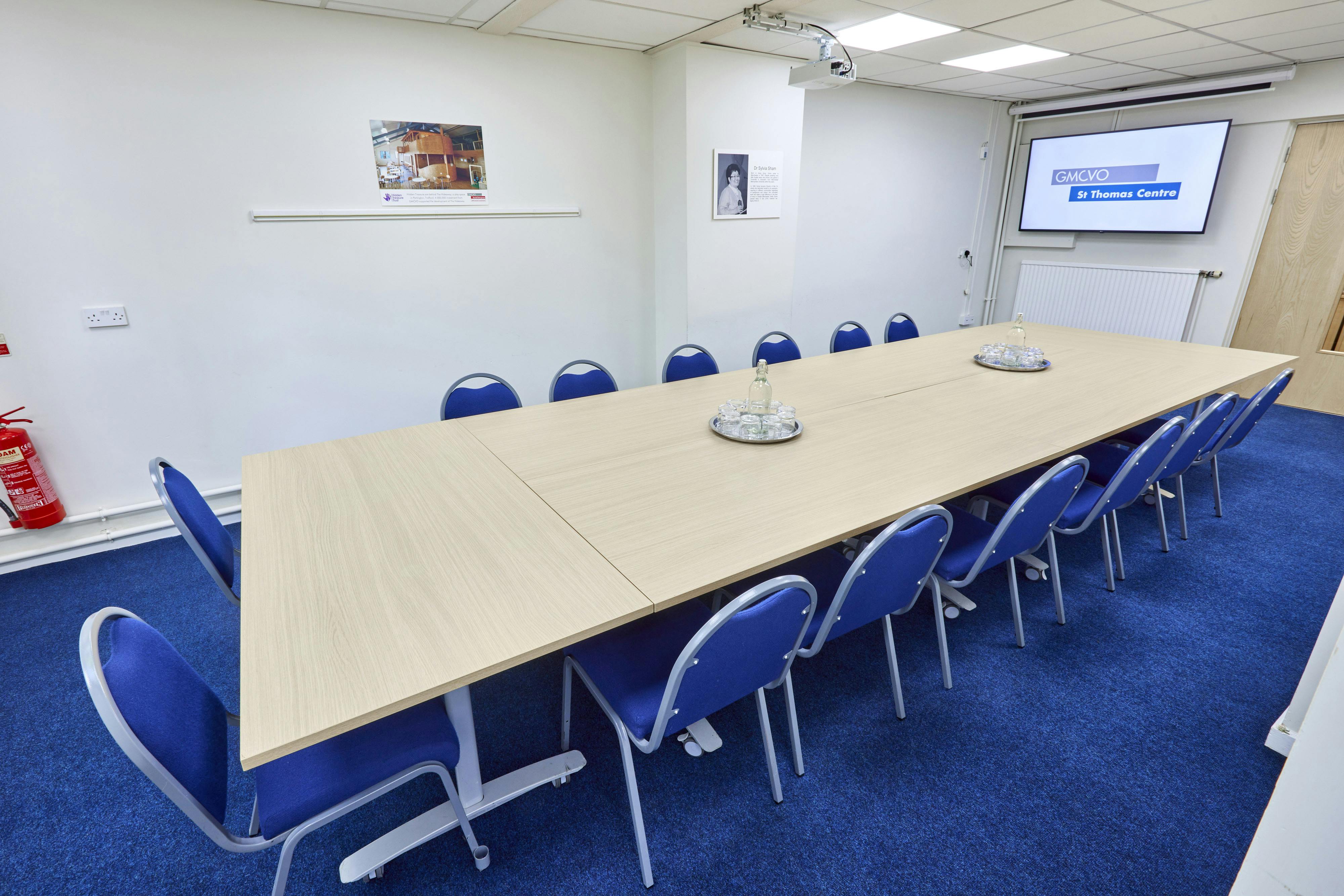 Sham Room in St Thomas Centre: modern meeting space with long table, ideal for workshops.