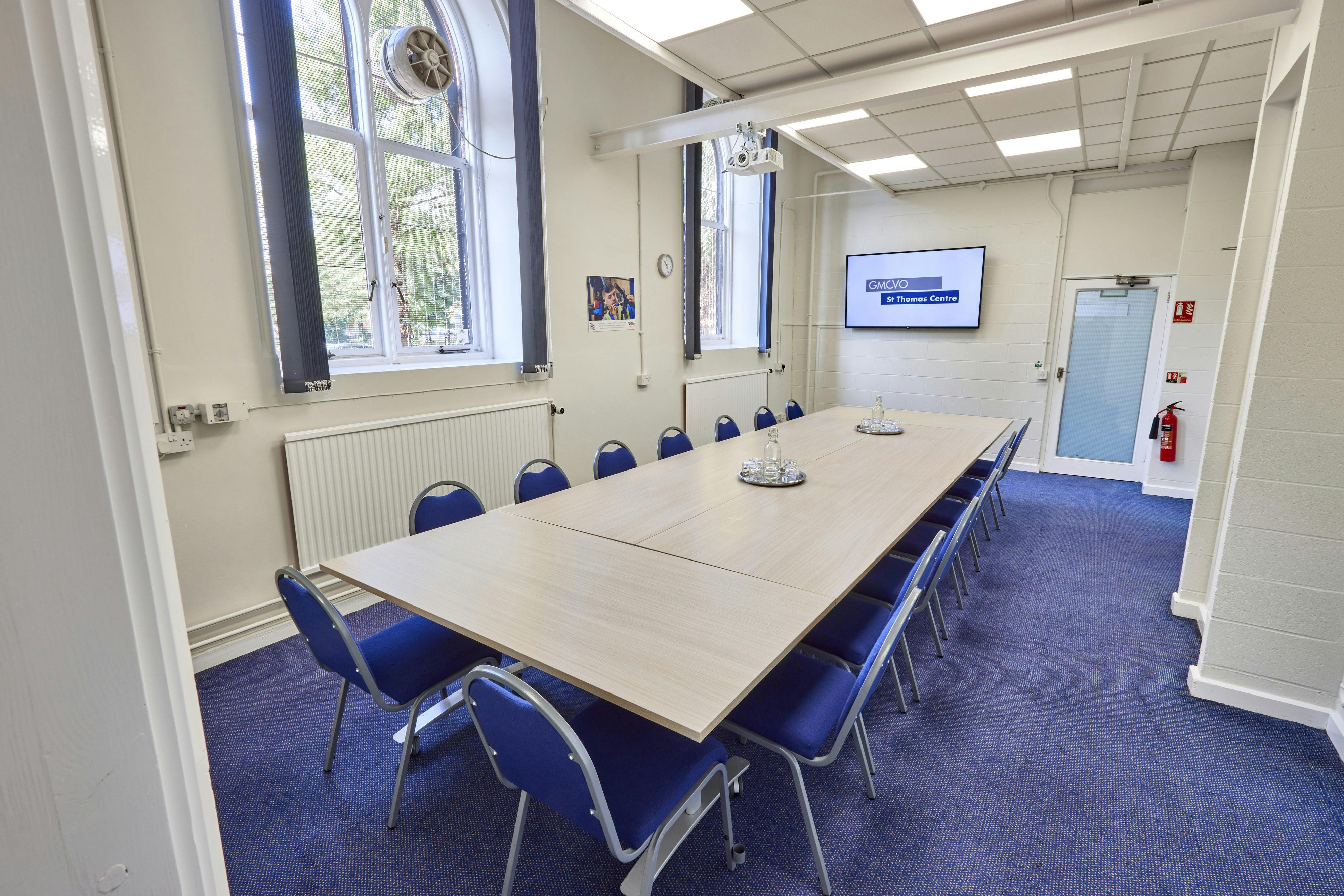 Gaskell Room at St Thomas Centre: bright meeting space with long table for workshops.