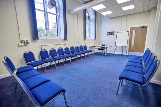 Mambu Room in St Thomas Centre: inviting workshop space with circular blue chairs.