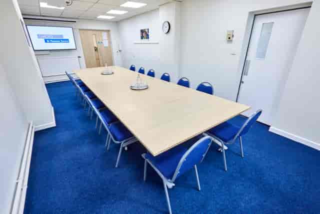 St Thomas Centre meeting room with blue chairs, ideal for corporate workshops.