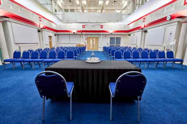 St Thomas Centre meeting space with blue chairs, ideal for workshops and presentations.