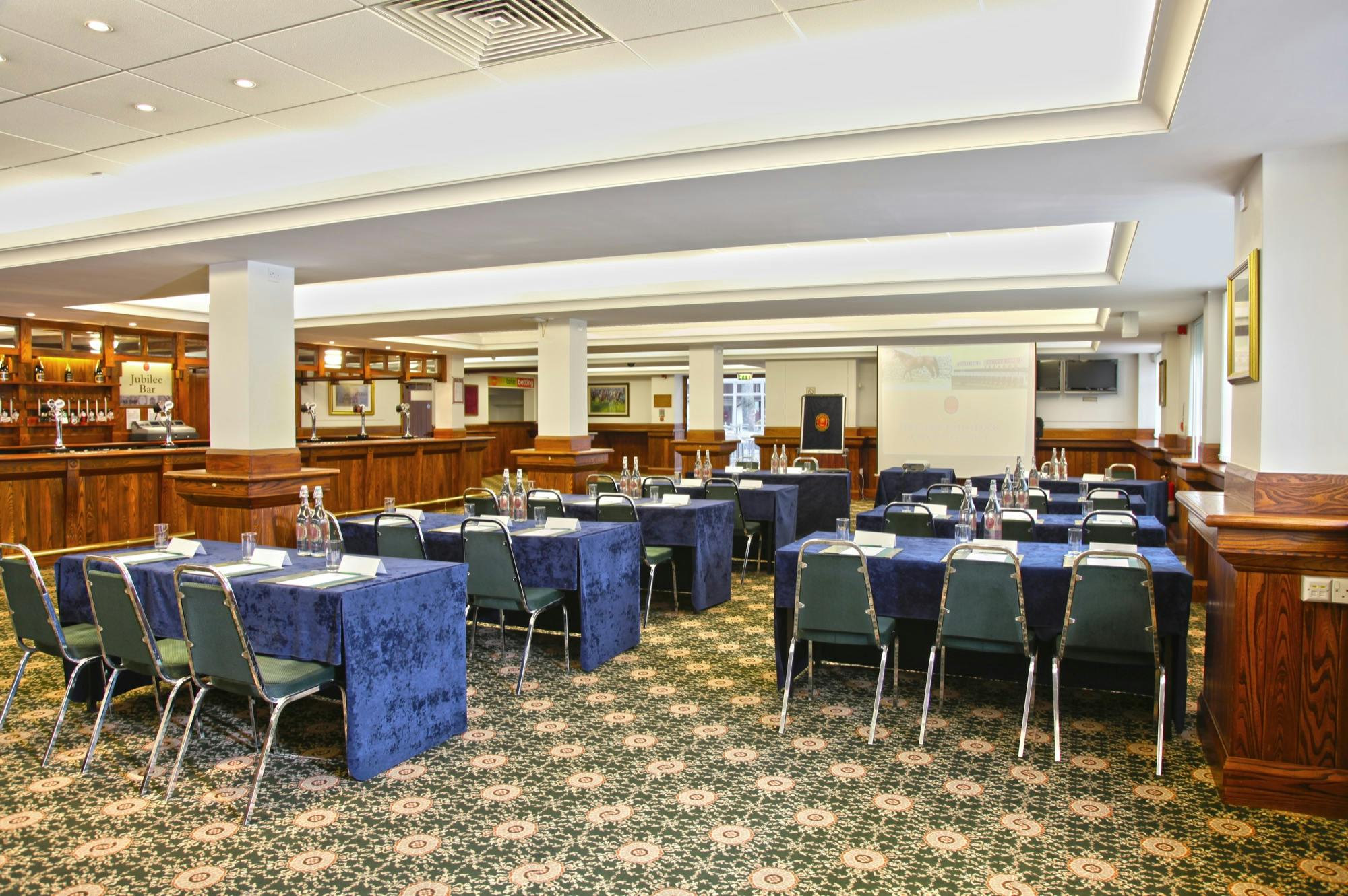 Jubilee suite at Haydock Park: bright meeting space with blue tables for workshops and presentations.