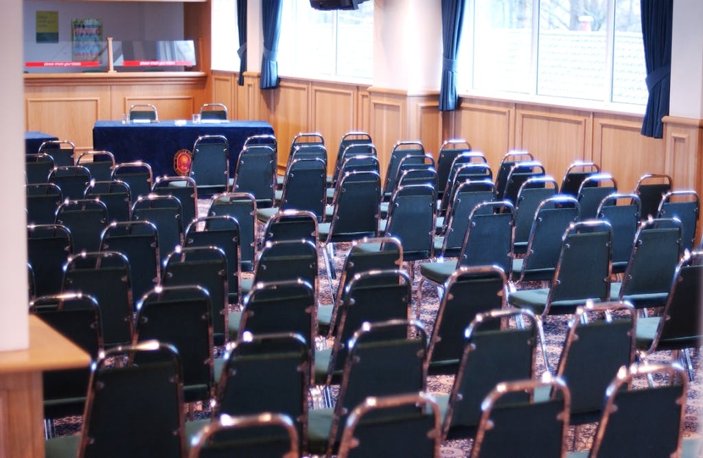 Whittle Suite at Haydock Park: bright meeting space with green chairs for conferences.