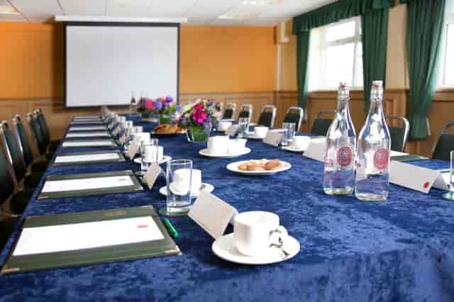 Syndicate Rooms at Haydock Park: elegant meeting space with blue linens for events.