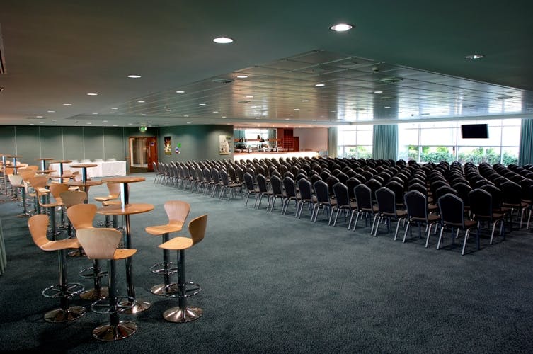Spacious Kia Oval Ashes Suite set for a conference with modern design and natural light.