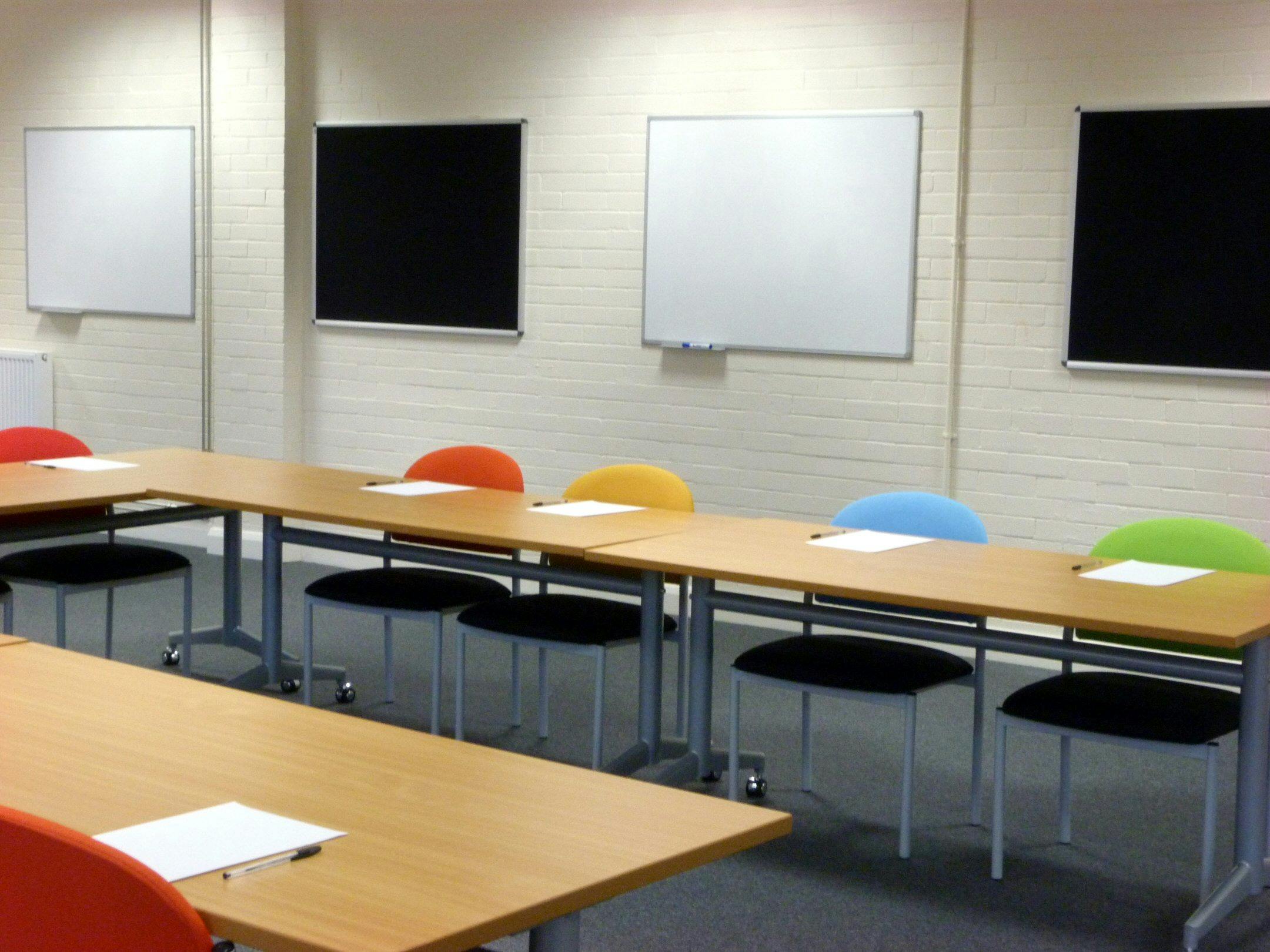 Training Room 1 at Redbank House with colorful chairs for workshops and team meetings.