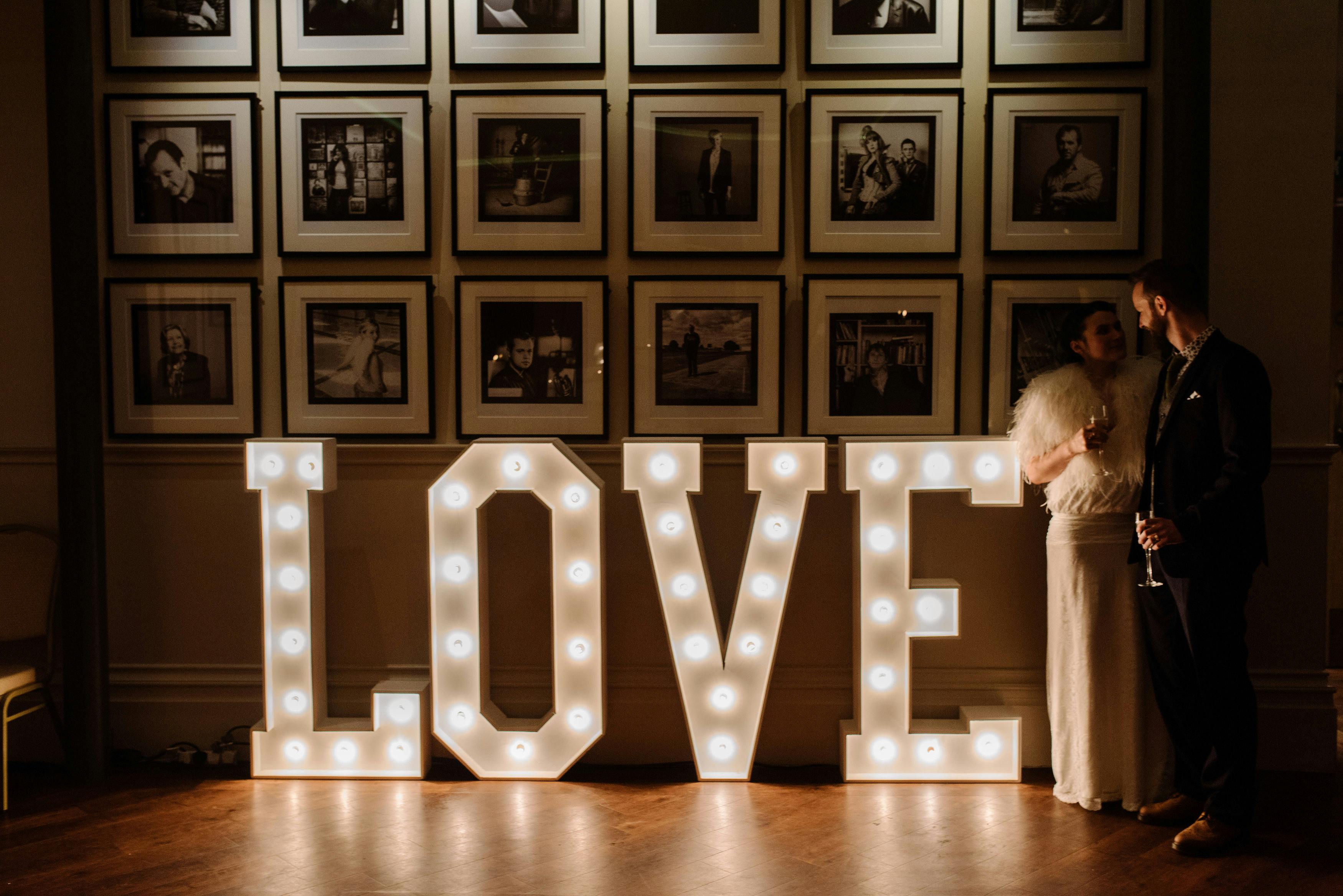 Thomas Worthington Room wedding reception with illuminated "LOVE" sign and elegant decor.