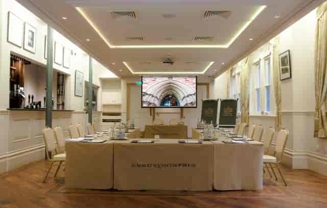 Memorial Hall meeting room with central table, ideal for corporate events and presentations.