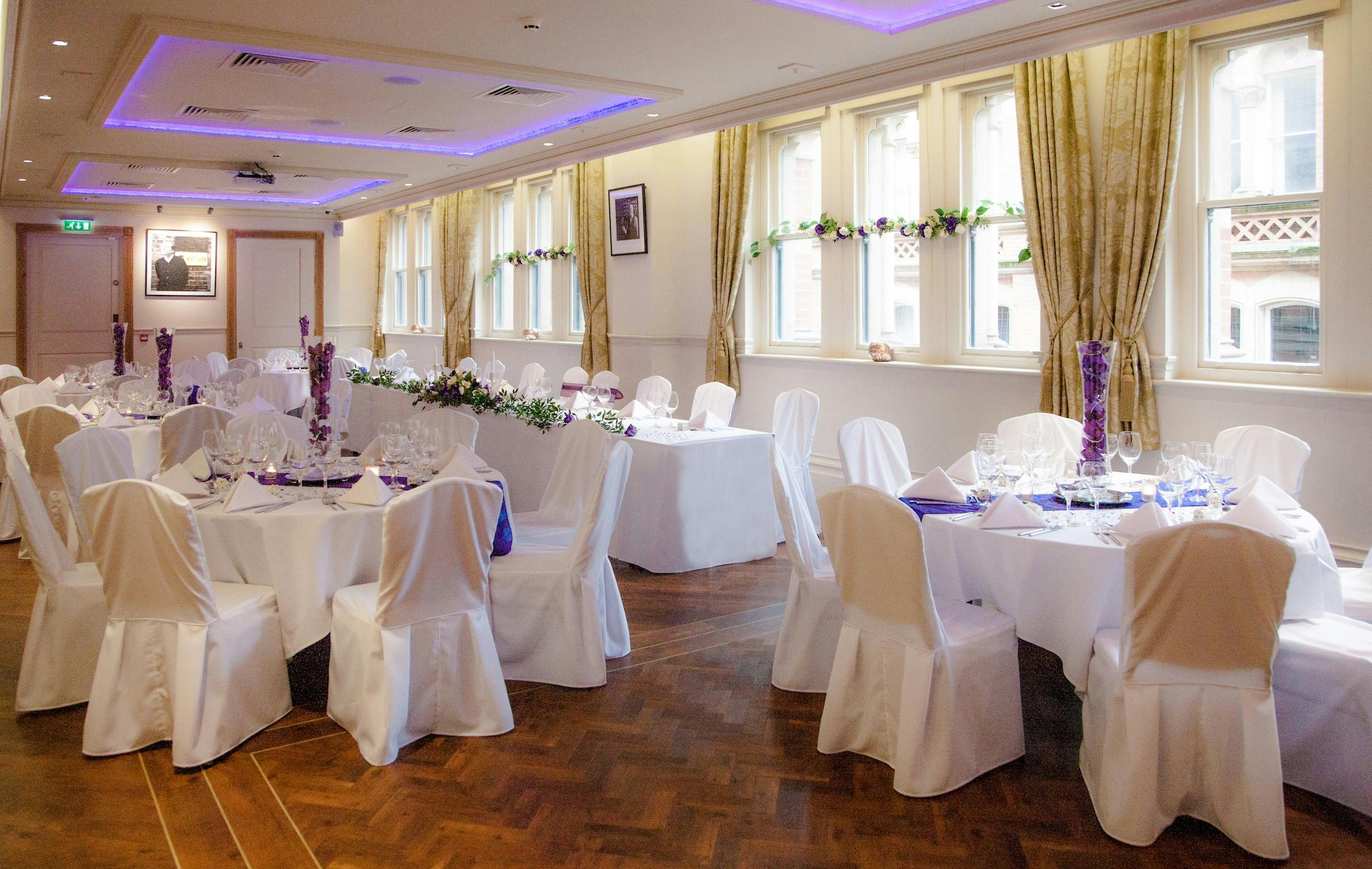 Elegant Memorial Hall event space with white linens, perfect for weddings and corporate events.