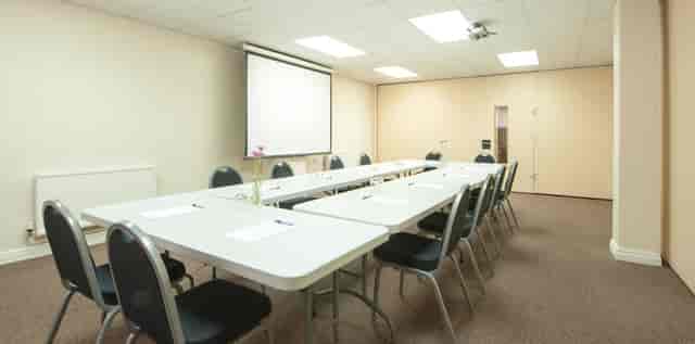 Seminar Room 4 at King's House: organized meeting space with projector for conferences.