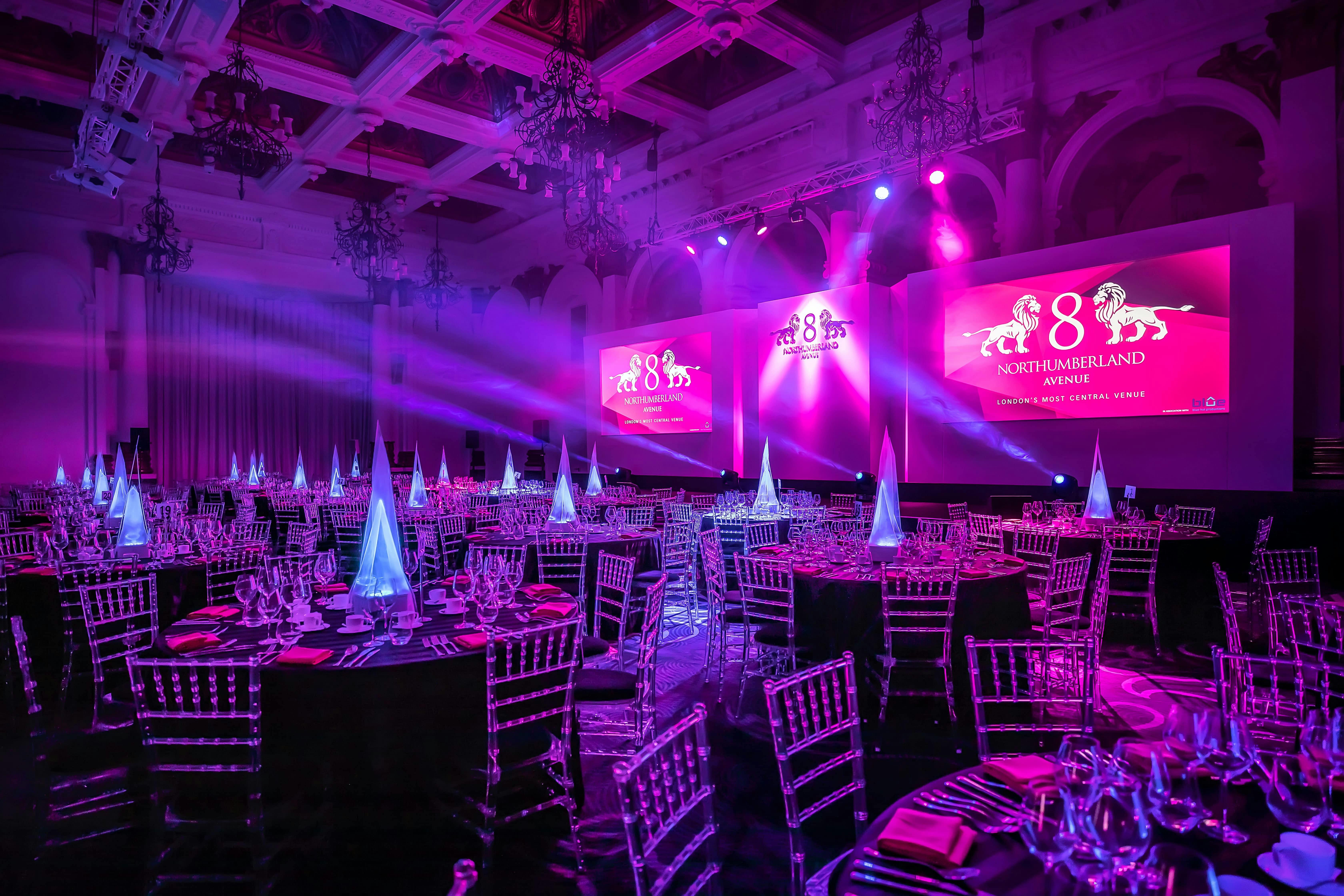 Sophisticated gala venue with illuminated centerpieces for corporate events.