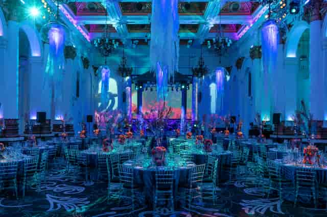 Elegant gala venue with floral centerpieces and ambient lighting for corporate events.
