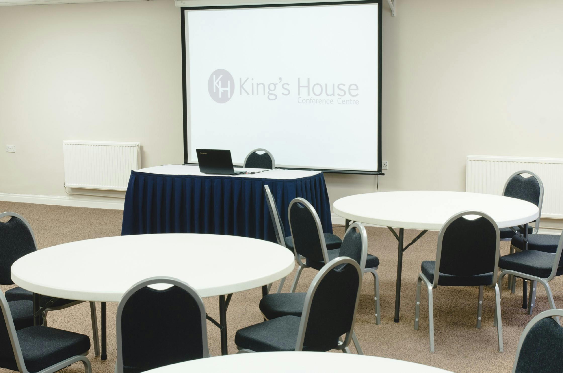 Seminar Room 3/4 at King's House: round tables for workshops and small conferences.