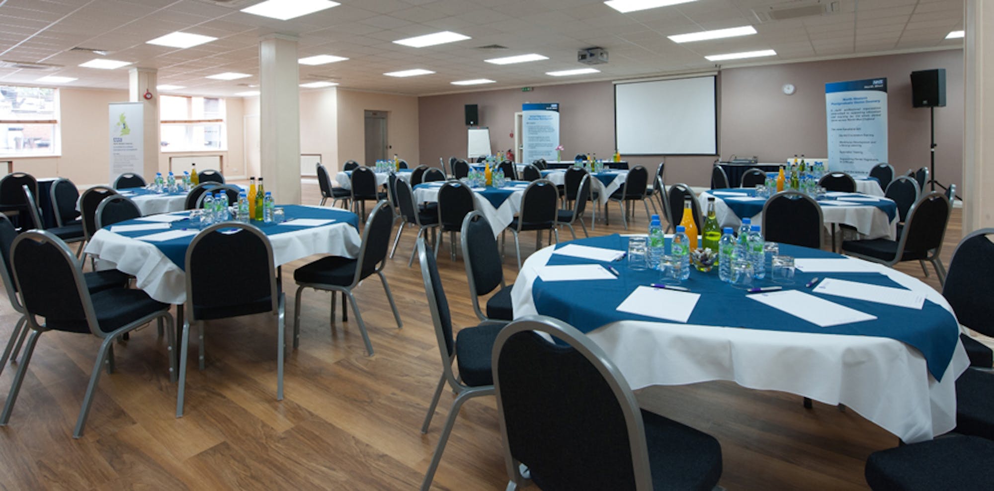 First Floor Hall at King's House: organized meeting space with round tables for professional events.