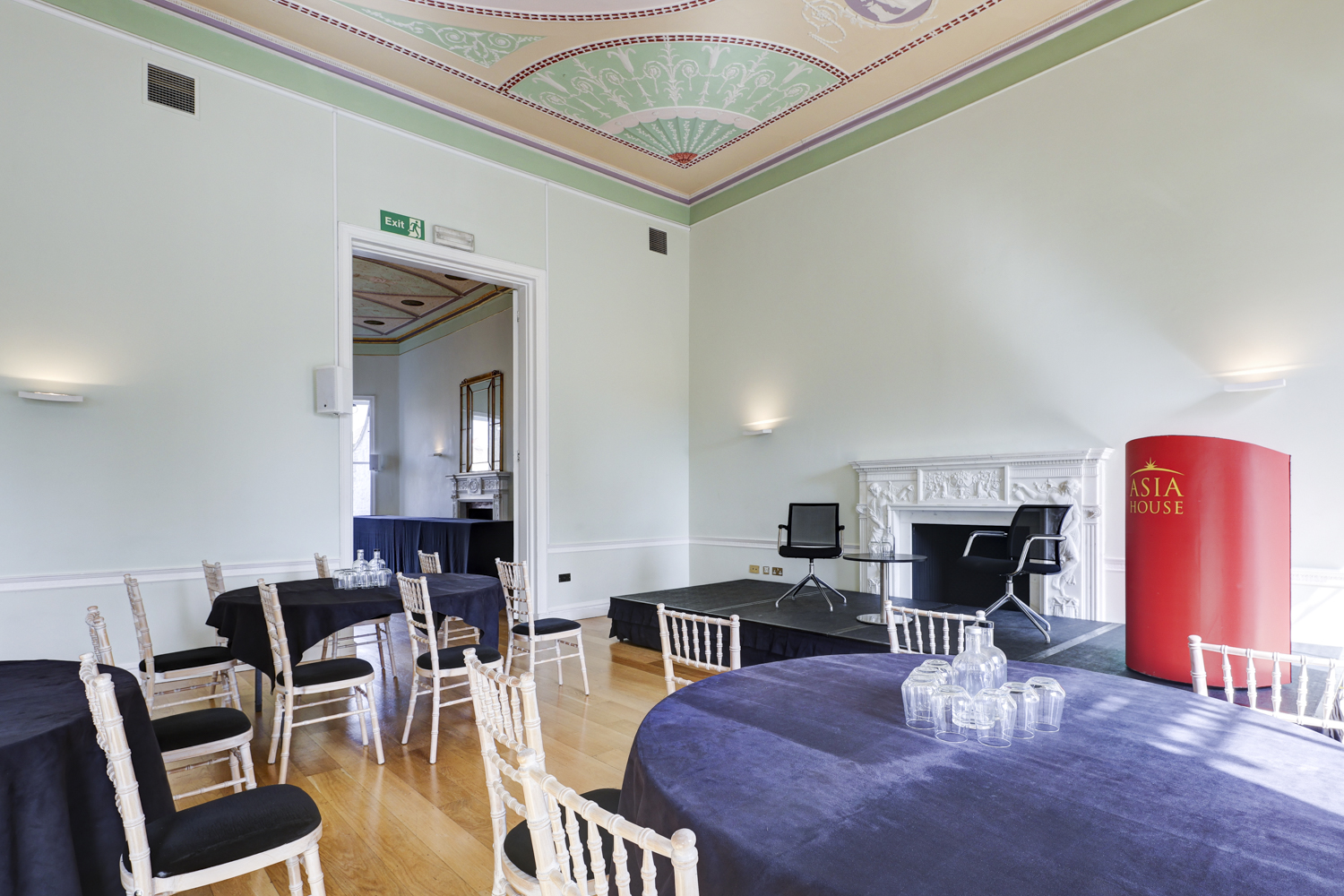 Elegant meeting room with round tables, ideal for events and presentations in Asia House. - Banner