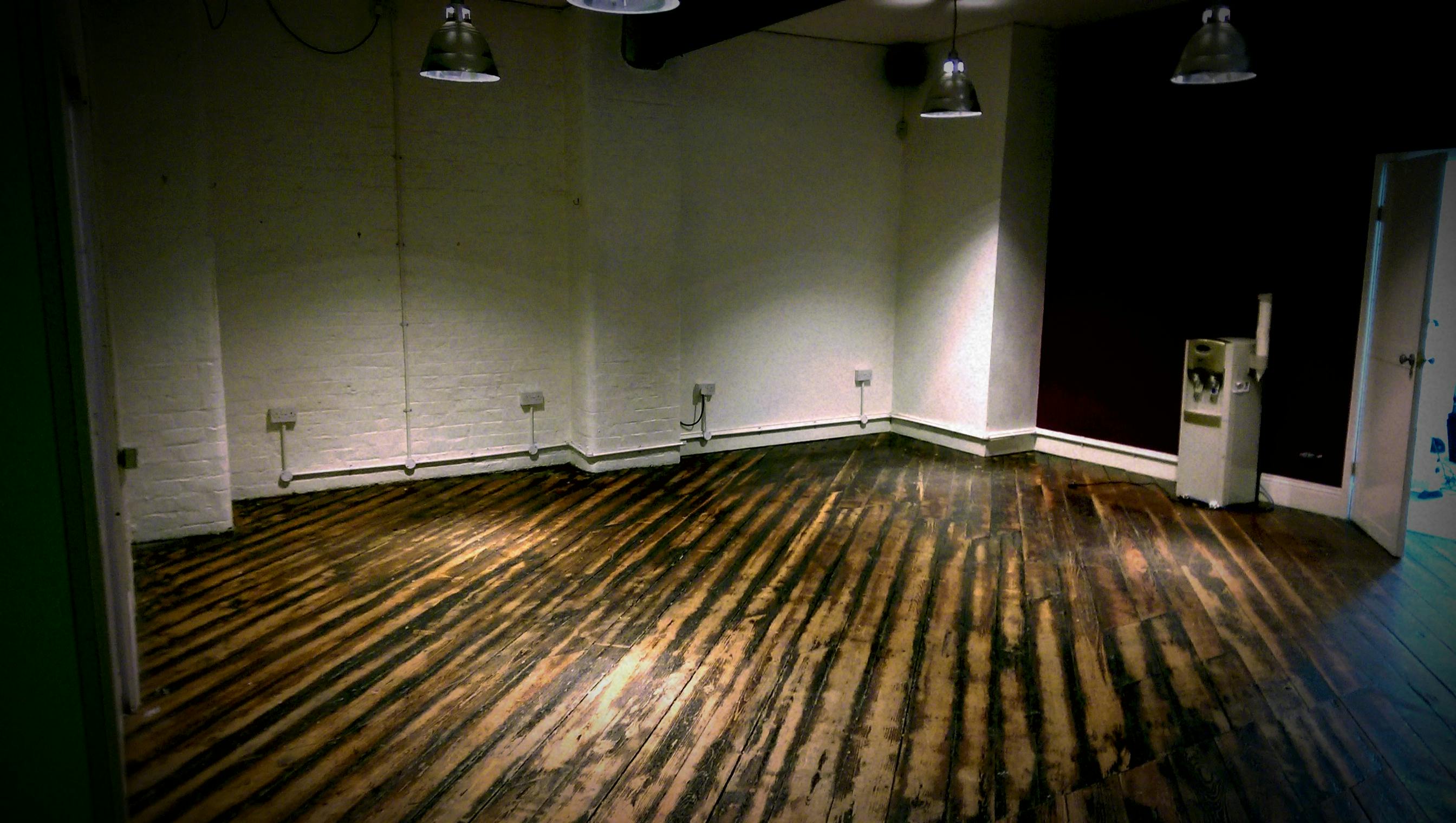 Versatile event space with rustic wooden floor for meetings and workshops at 47 Dale Street.