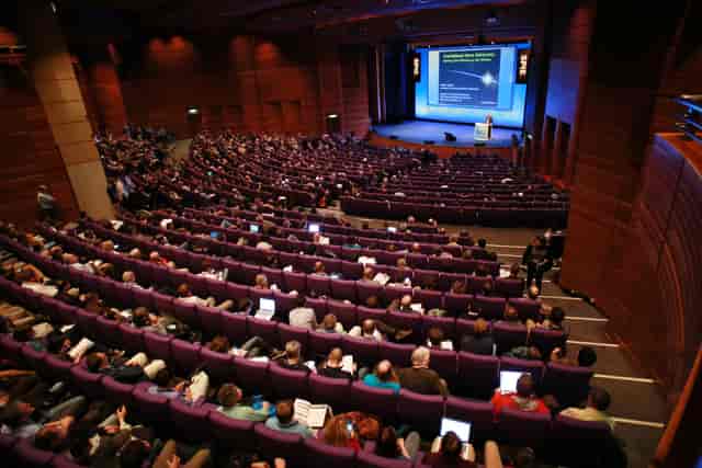 Pentland Auditorium conference with tiered seating and engaging speaker presentation.
