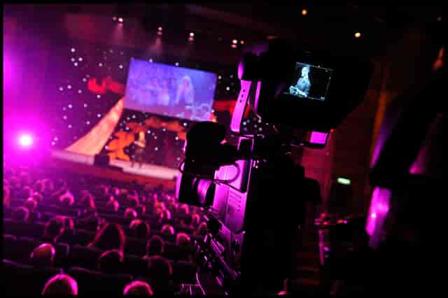 Pentland Auditorium event setup with speaker, audience, and vibrant lighting.