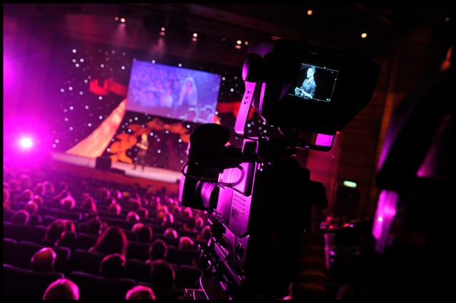 Pentland Auditorium event setup with speaker, audience, and vibrant lighting.
