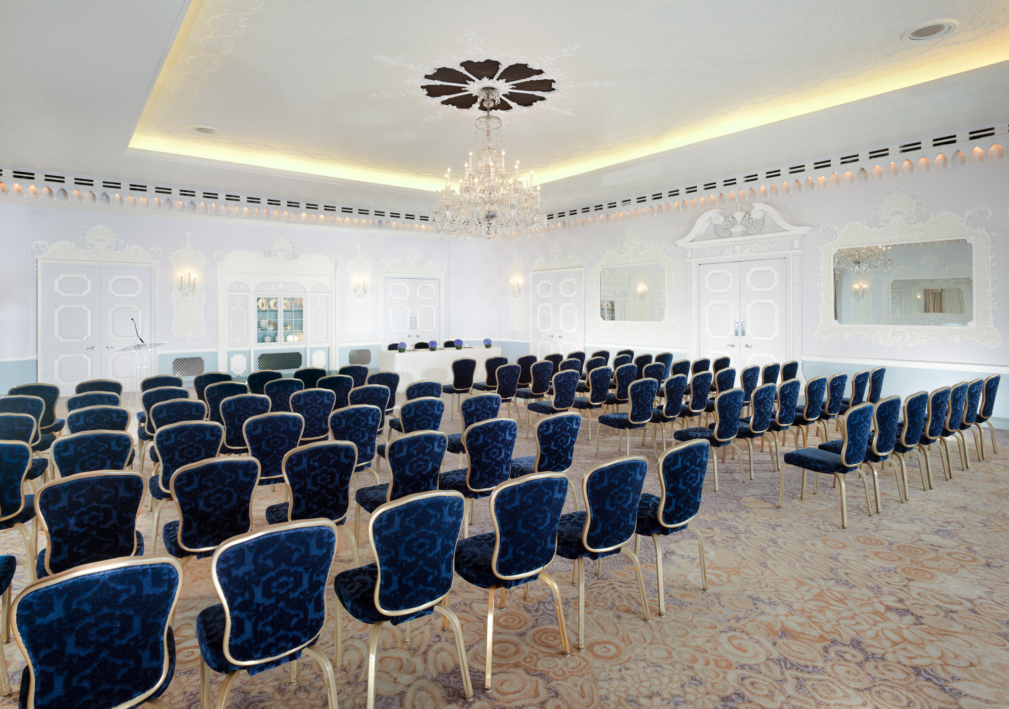 Sophisticated conference room with blue chairs, ideal for meetings and workshops. - Banner
