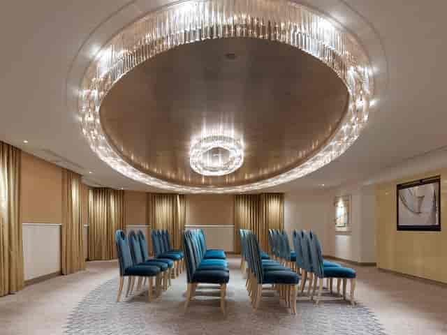 Elegant Crystal Suite meeting space with chandelier, perfect for intimate gatherings.