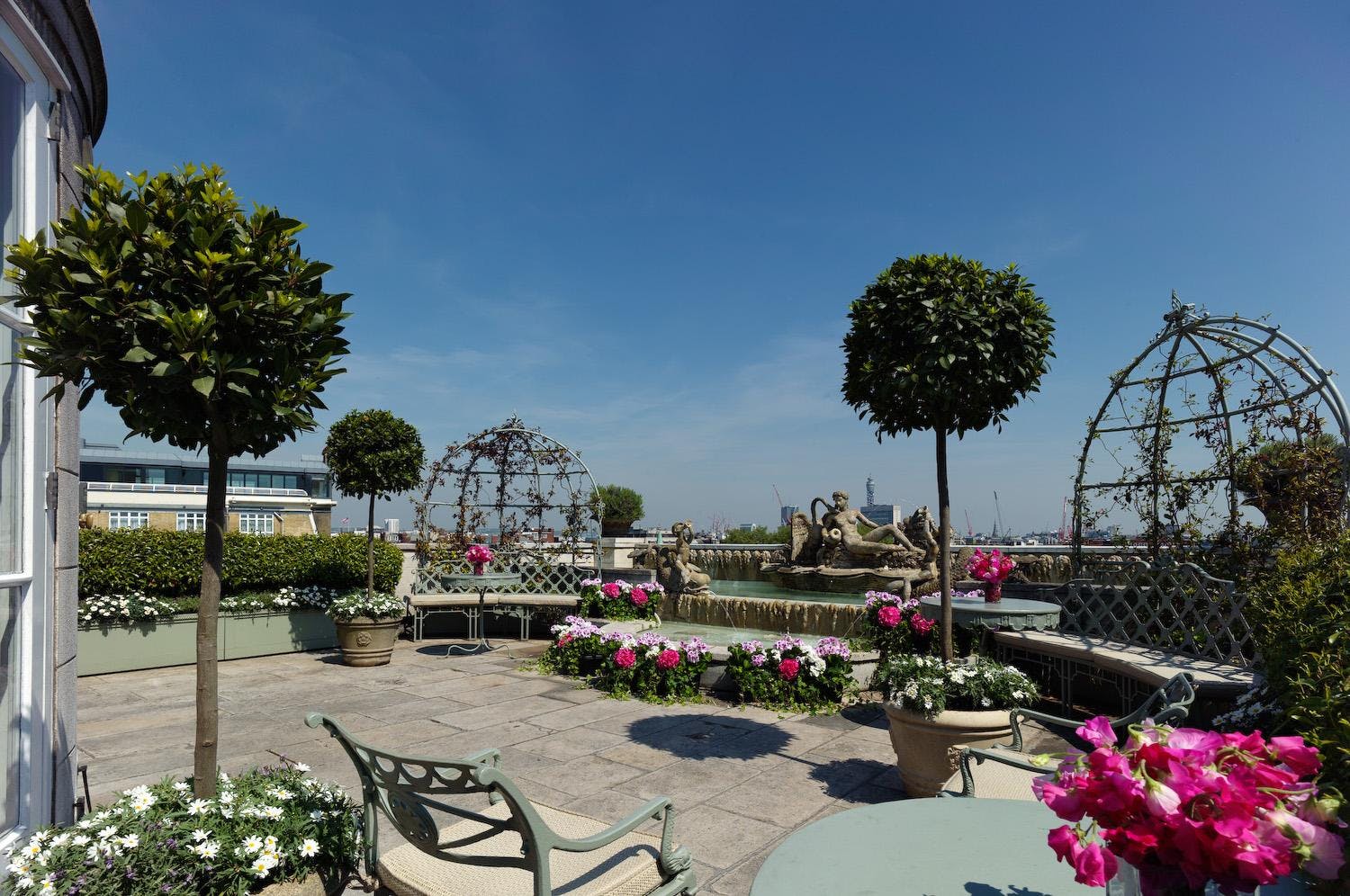 Penthouse terrace at The Dorchester, lush greenery for elegant events and gatherings.