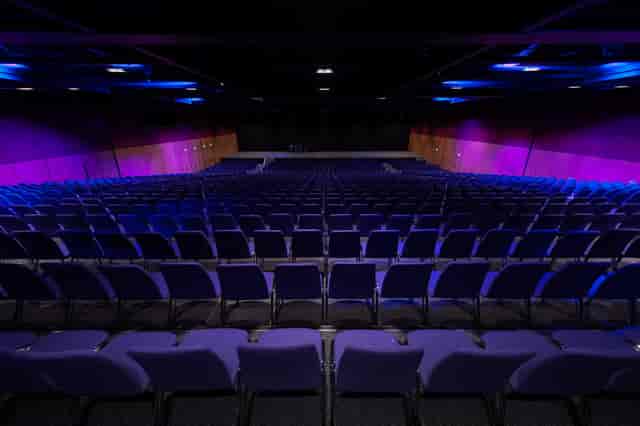 Lennox Suite auditorium with purple chairs, ideal for conferences and presentations.