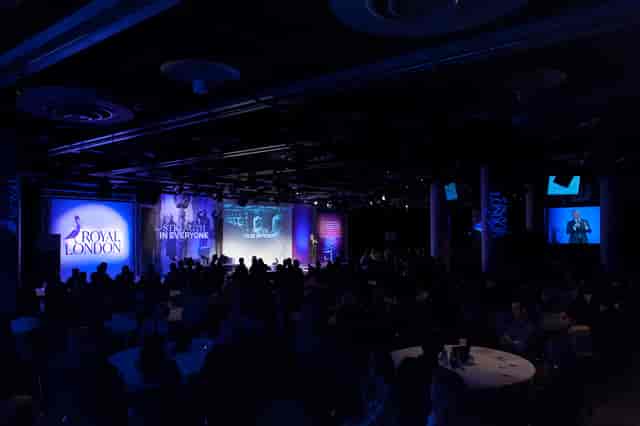 Cromdale Hall conference with dynamic stage and engaged audience in Edinburgh.