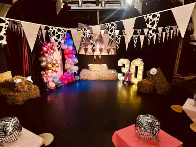 Kings Arms Theatre event space with rustic hay bales for a 30th birthday celebration.