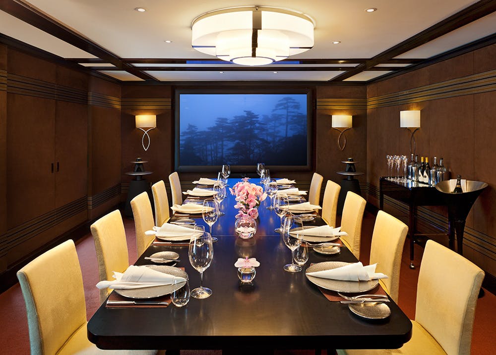 Sophisticated media room with elegant table, ideal for executive meetings and networking events.