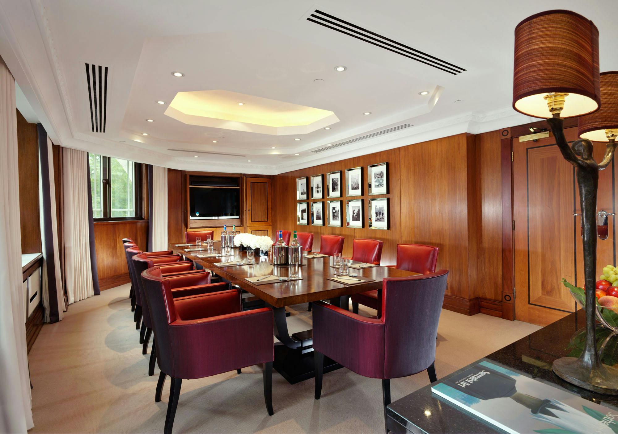 Sophisticated meeting room at The Dorchester with elegant wooden paneling, ideal for conferences.