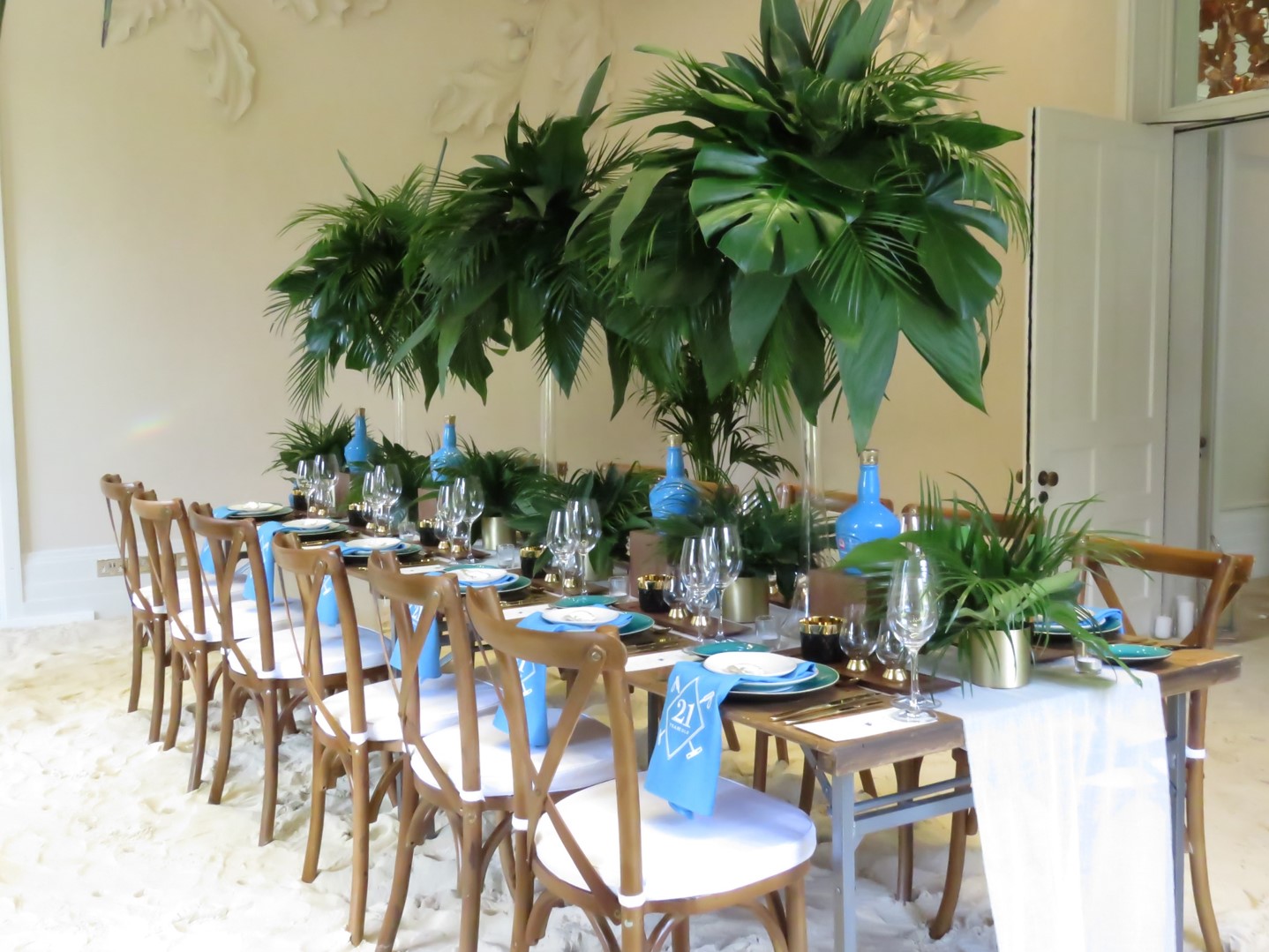 Elegant dining setup in Oak Room, Coworth Park with natural wood and greenery for events.