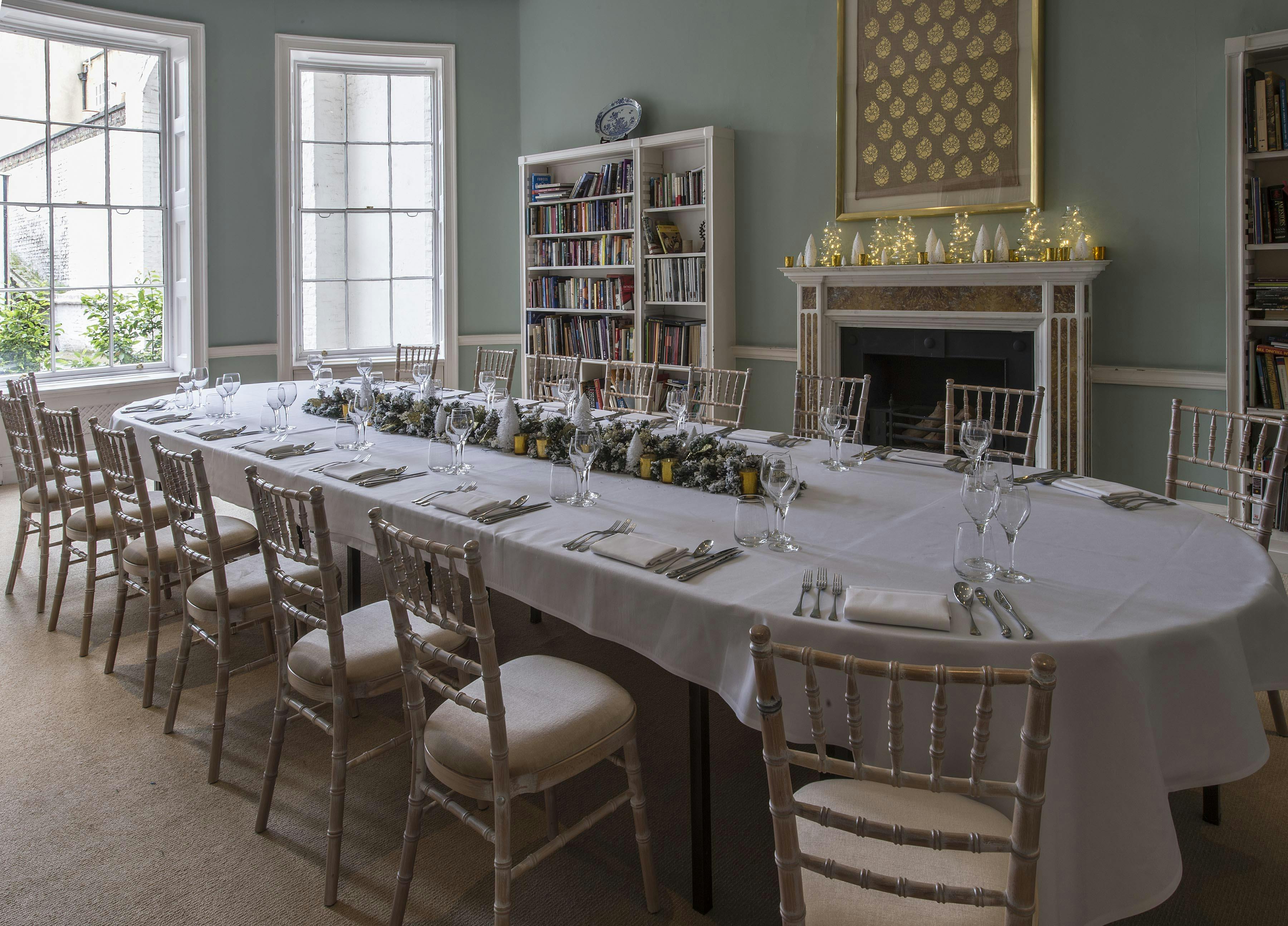 Elegant meeting space in Asia House with elongated table, ideal for discussions and events.