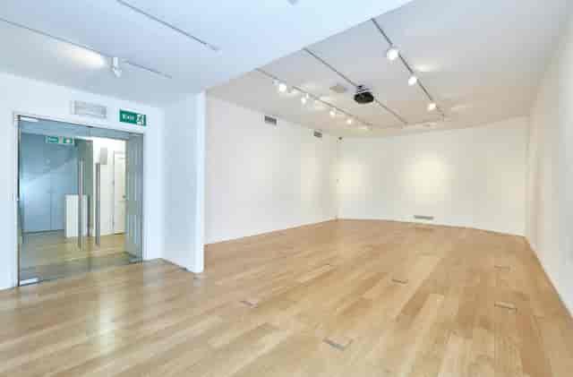 Versatile event space in Asia House with natural light, ideal for meetings and exhibitions.