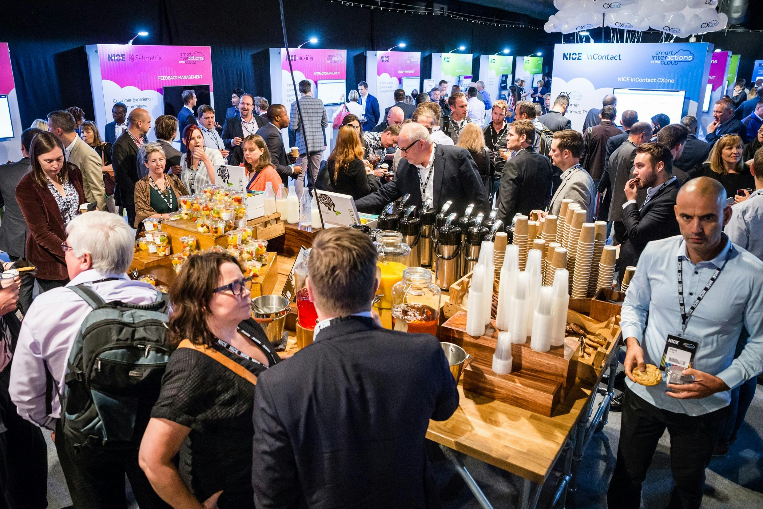 Networking event in Chelsea FC's Great Hall with attendees around a refreshment station.