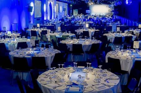 Elegant event setup in Chelsea FC's Great Hall with fine dining and ambient lighting.