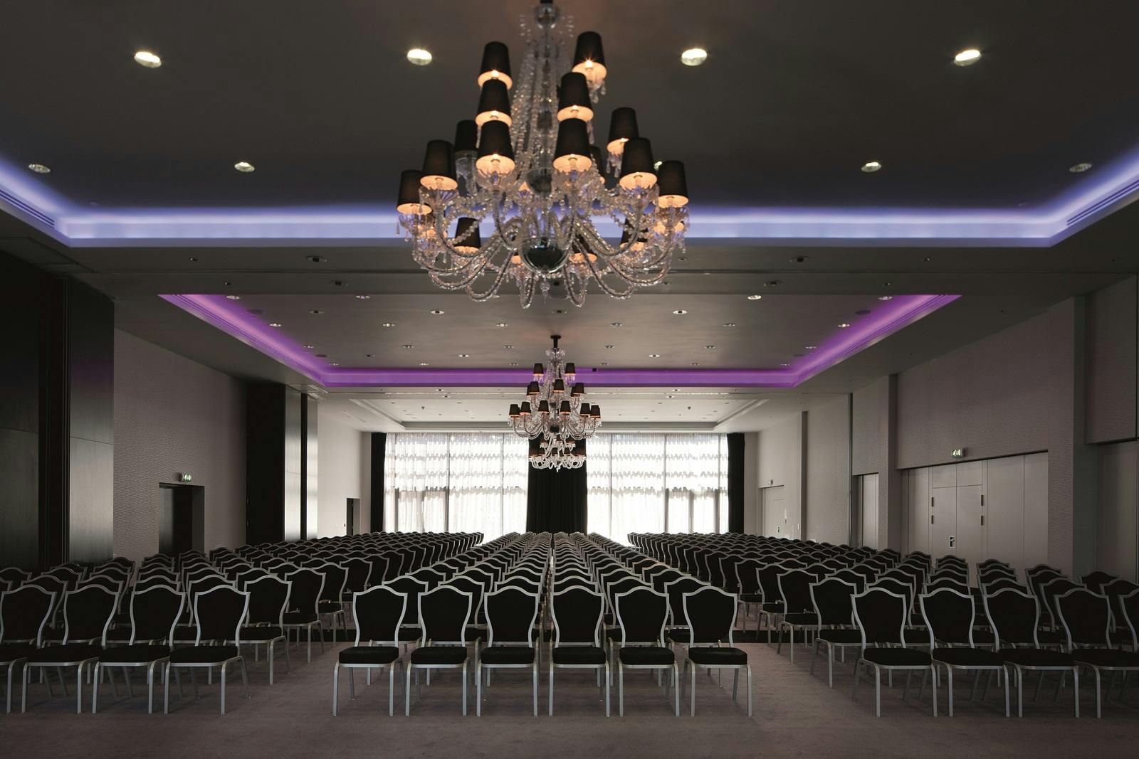 Grand Syon Ballroom with elegant chandeliers, perfect for conferences and gatherings.