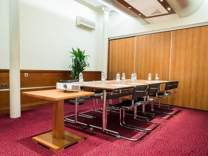 Meeting room in Townhouse Hotel Manchester, featuring a long table for workshops and presentations.